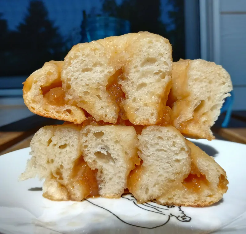 pull-apart bread pulled open to show an amber fruit filling