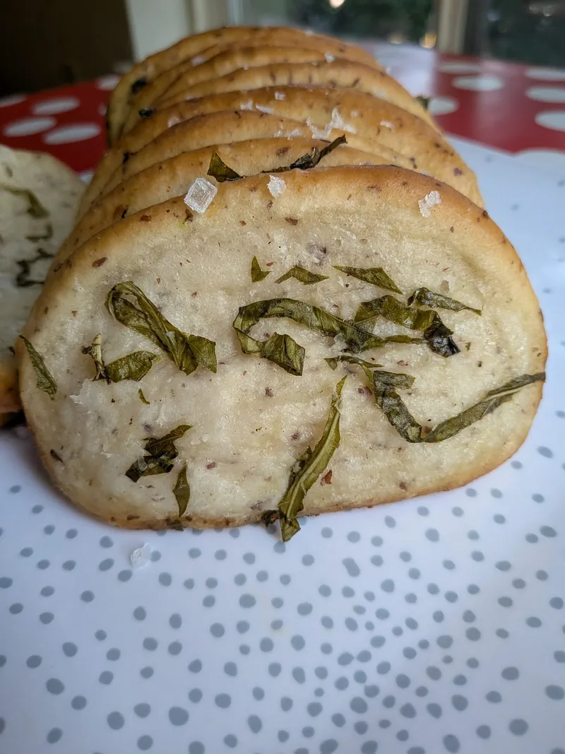 slices of sourdough garlic and basil butter pull-apart bread with flaky salt