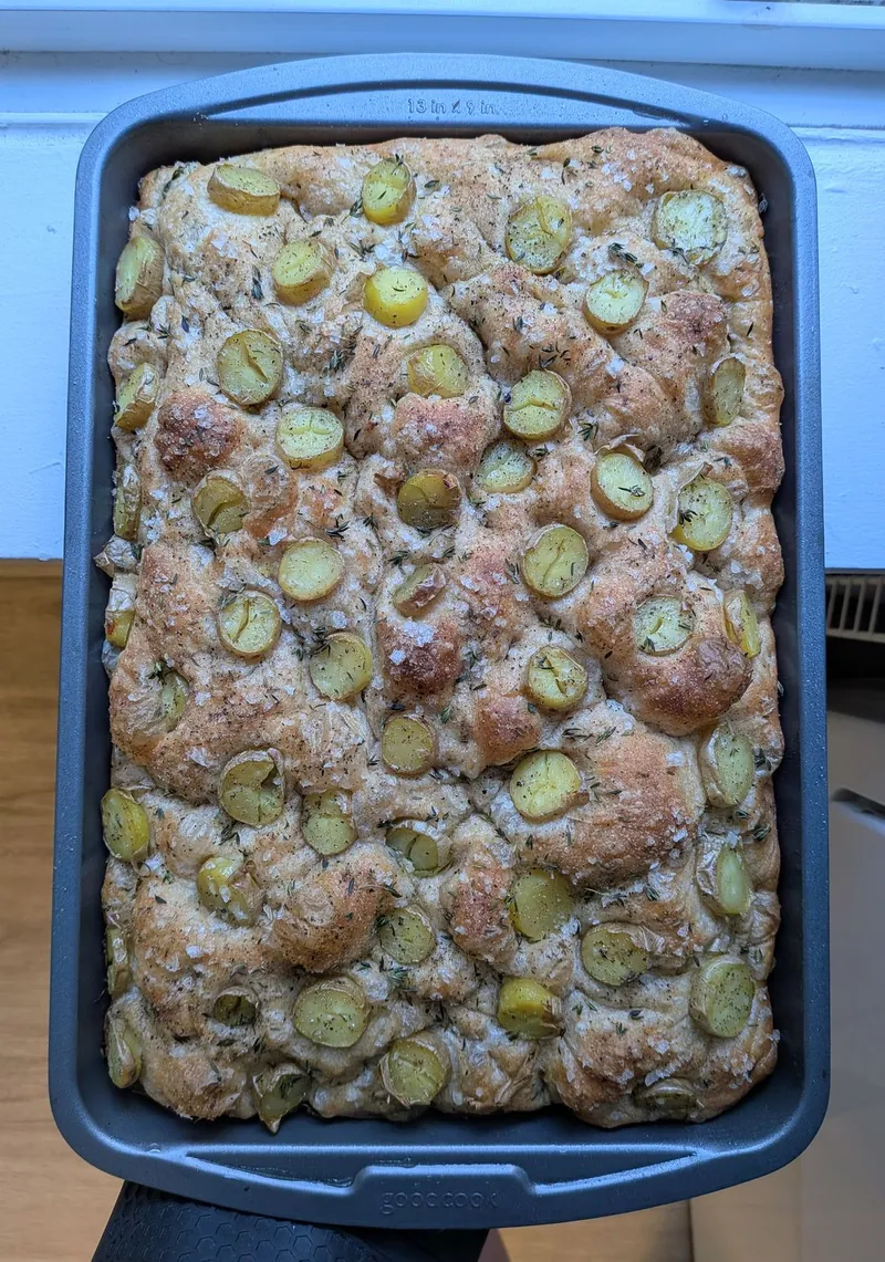 sheet-pan focaccia topped with halved green grapes, thyme and flaky salt