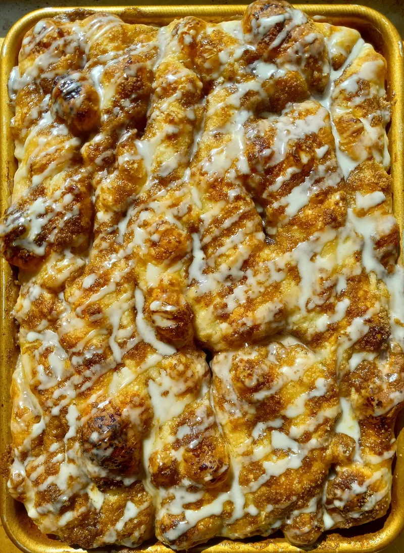 cinnamon sugar pull-apart bread in a sheet pan with an icing drizzle
