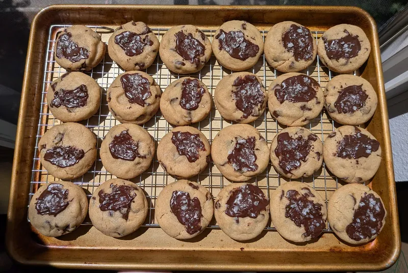 a full rack of salted chocolate chip cookies with melted chocolate and flaky salt