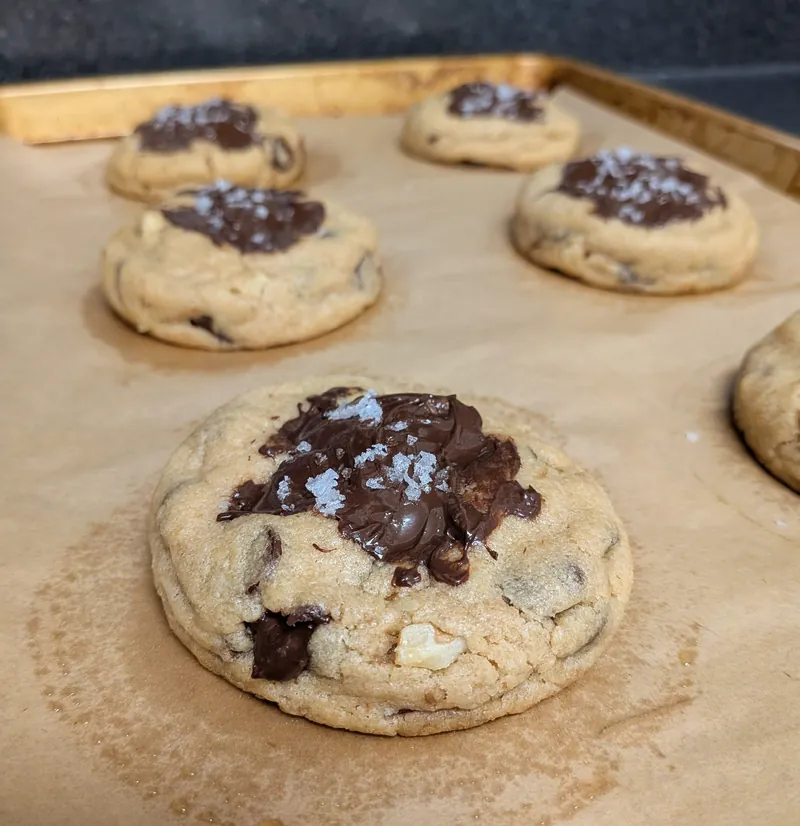 salted chocolate chip walnut cookies with melted chocolate and flaky salt