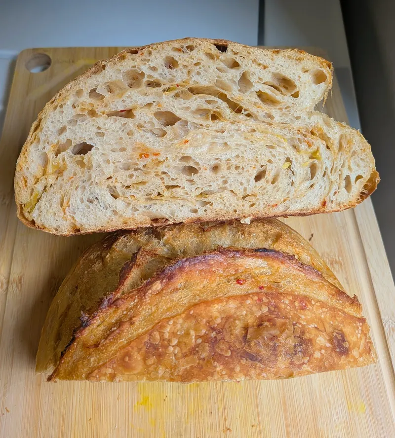 a sourdough loaf cut open on a wooden board